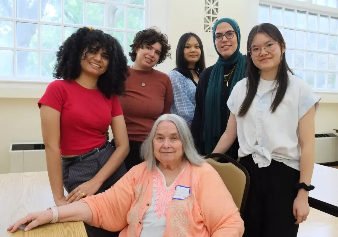 Fiona Shen '27, Nada Elshafey '26, Anna Nguyen '25, Emma Dermansky '27, and Isbah Ameer '26 stand for a photo with Ann Doley, seated.